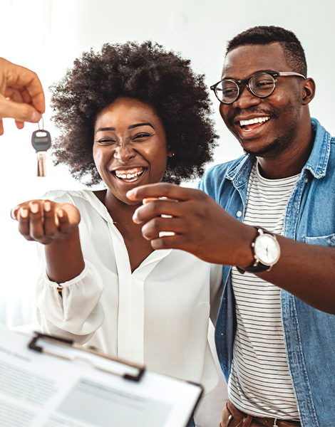 Happy couple receiving new house keys